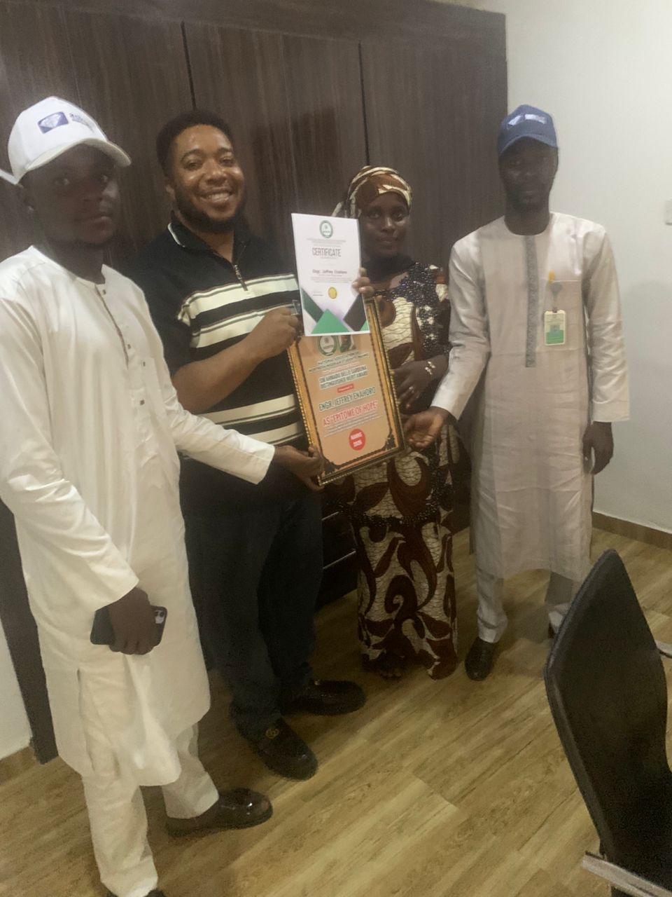 Jeffrey Enahoro Receiving Award Plaque from Student Leaders