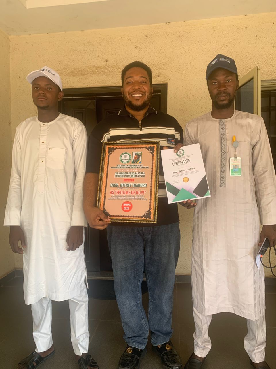 Jeffrey Enahoro Discussing Award Details in Office